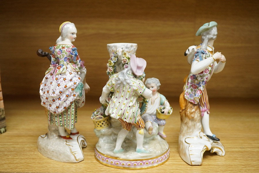 A 19th century Jacob Petit urn group and two similar porcelain figures of musicians, each signed to the bases, largest 20cm high (3). Condition - fair